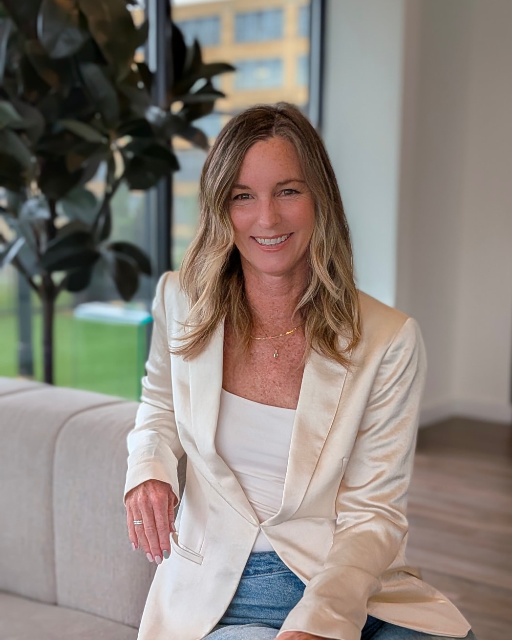 Heather MacLaren smiling, seated in a cream jacket